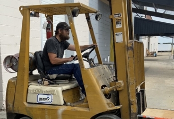 Man driving a warehouse loader.